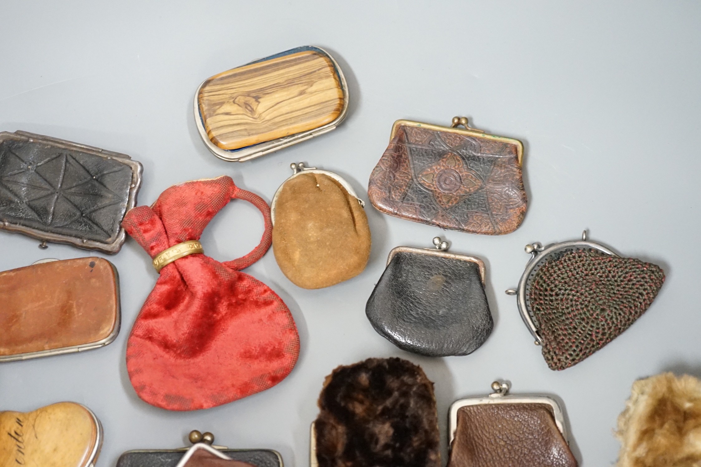 A collection of mostly Grand Tour, wooden souvenir purses and other 19th and 20th century leather and fur purses